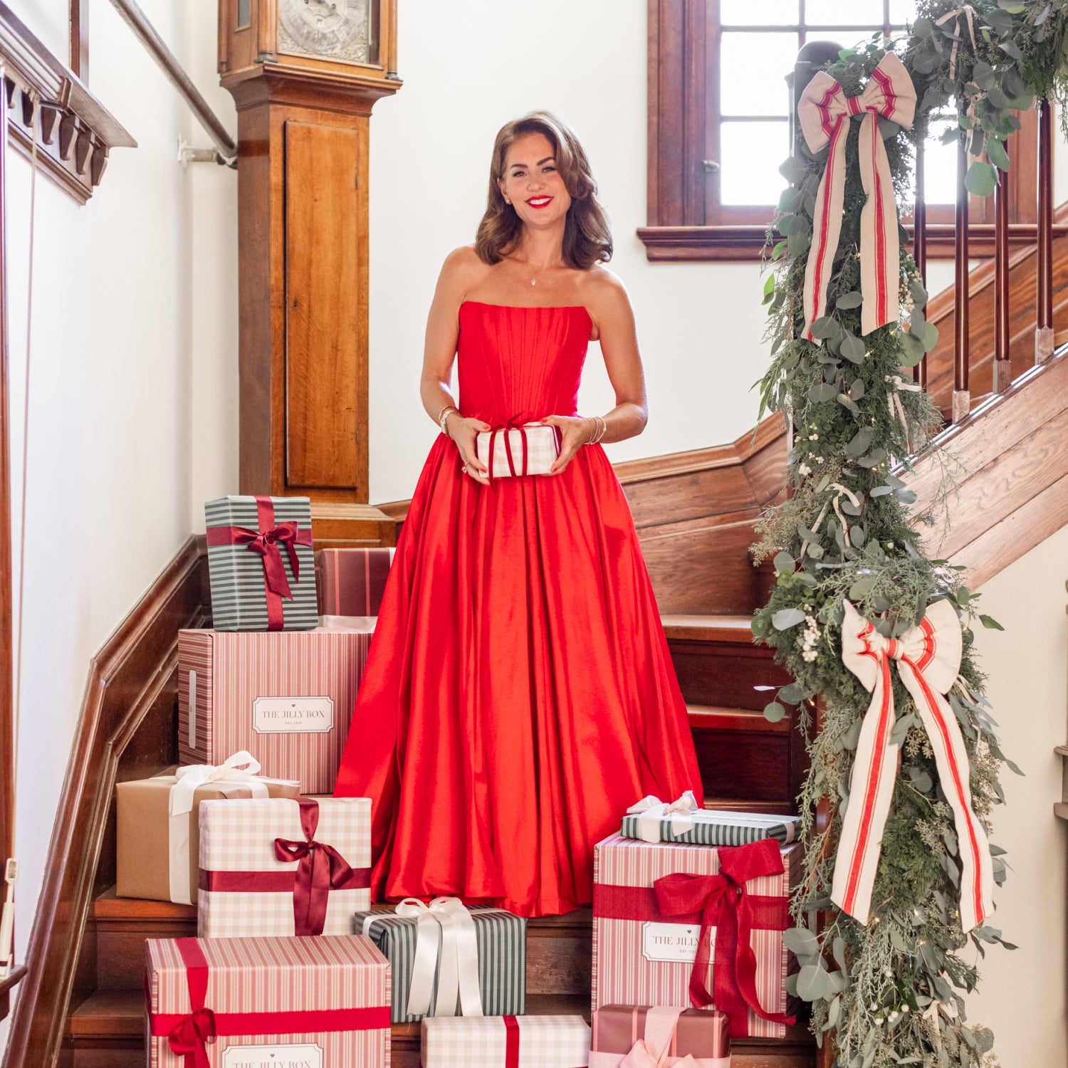 Jillian in a dress with presents around her